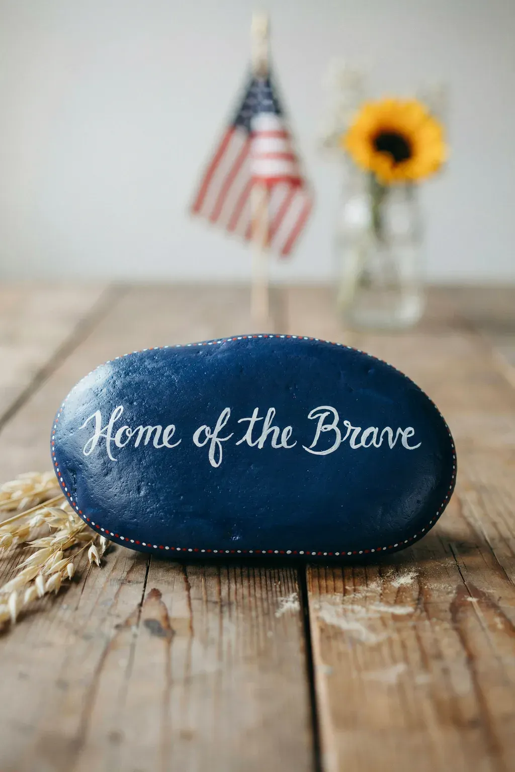 home of the brave hand lettered patriotic painted rocks ideas on farmhouse wood table